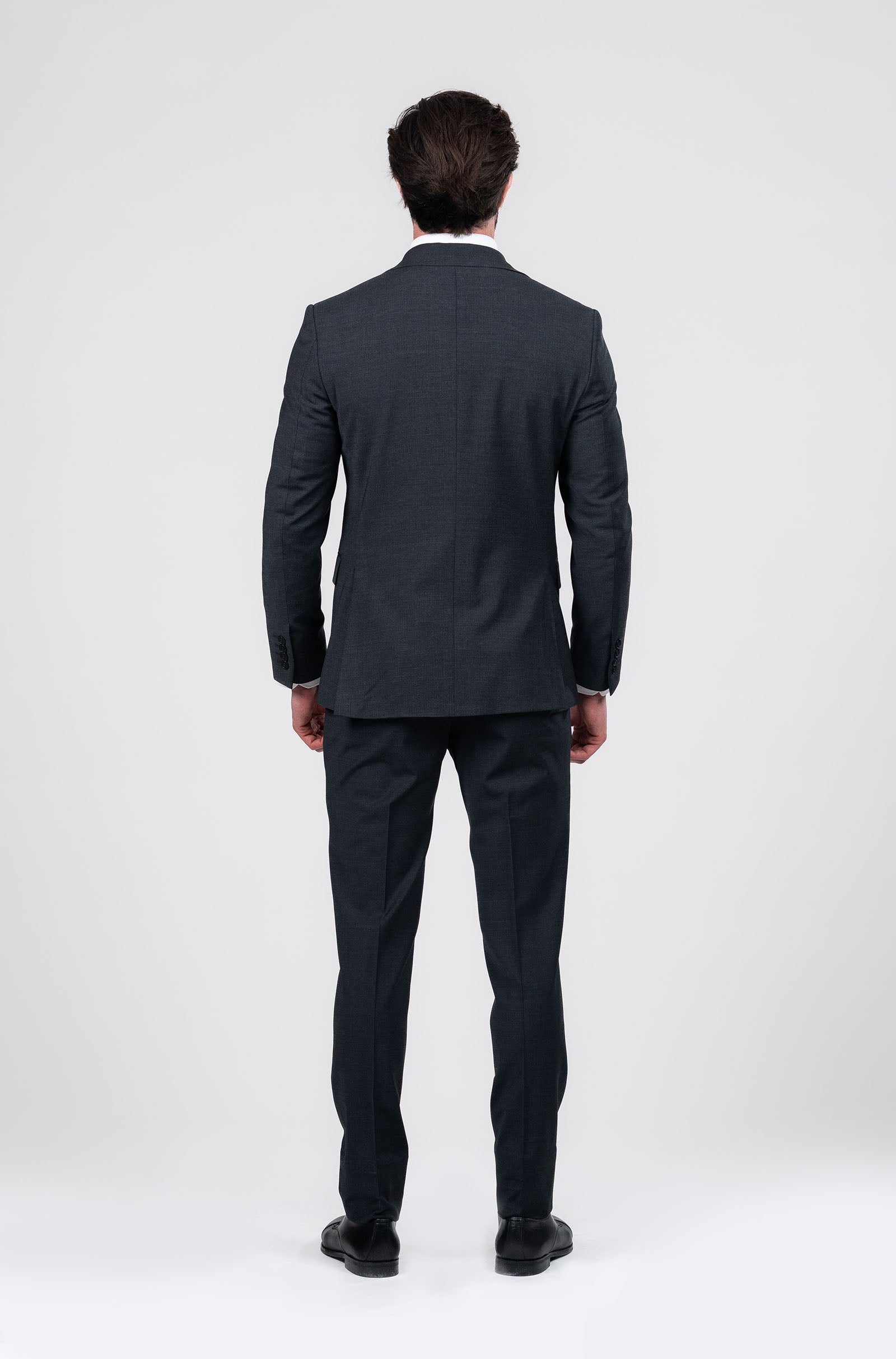 Man wearing a black suit on a white background