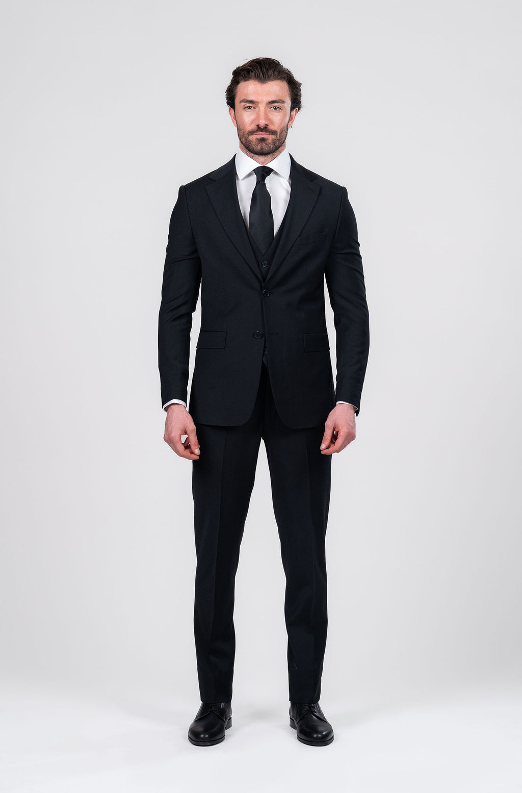 Man wearing a black suit on a white background