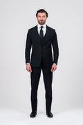 Man wearing a black suit on a white background