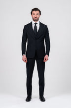 Man wearing a black suit on a white background