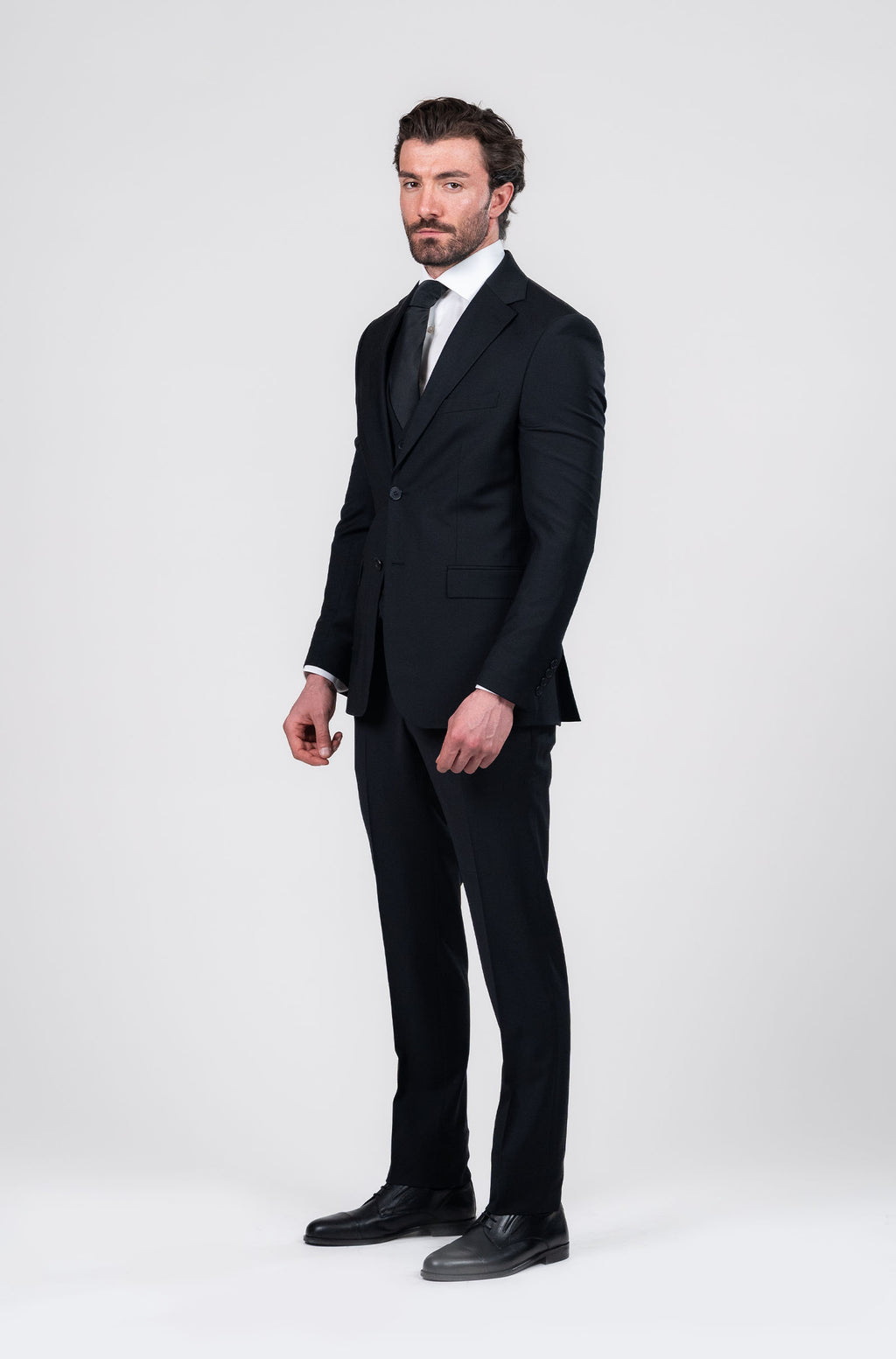 Man wearing a black suit on a white background