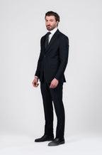 Man wearing a black suit on a white background
