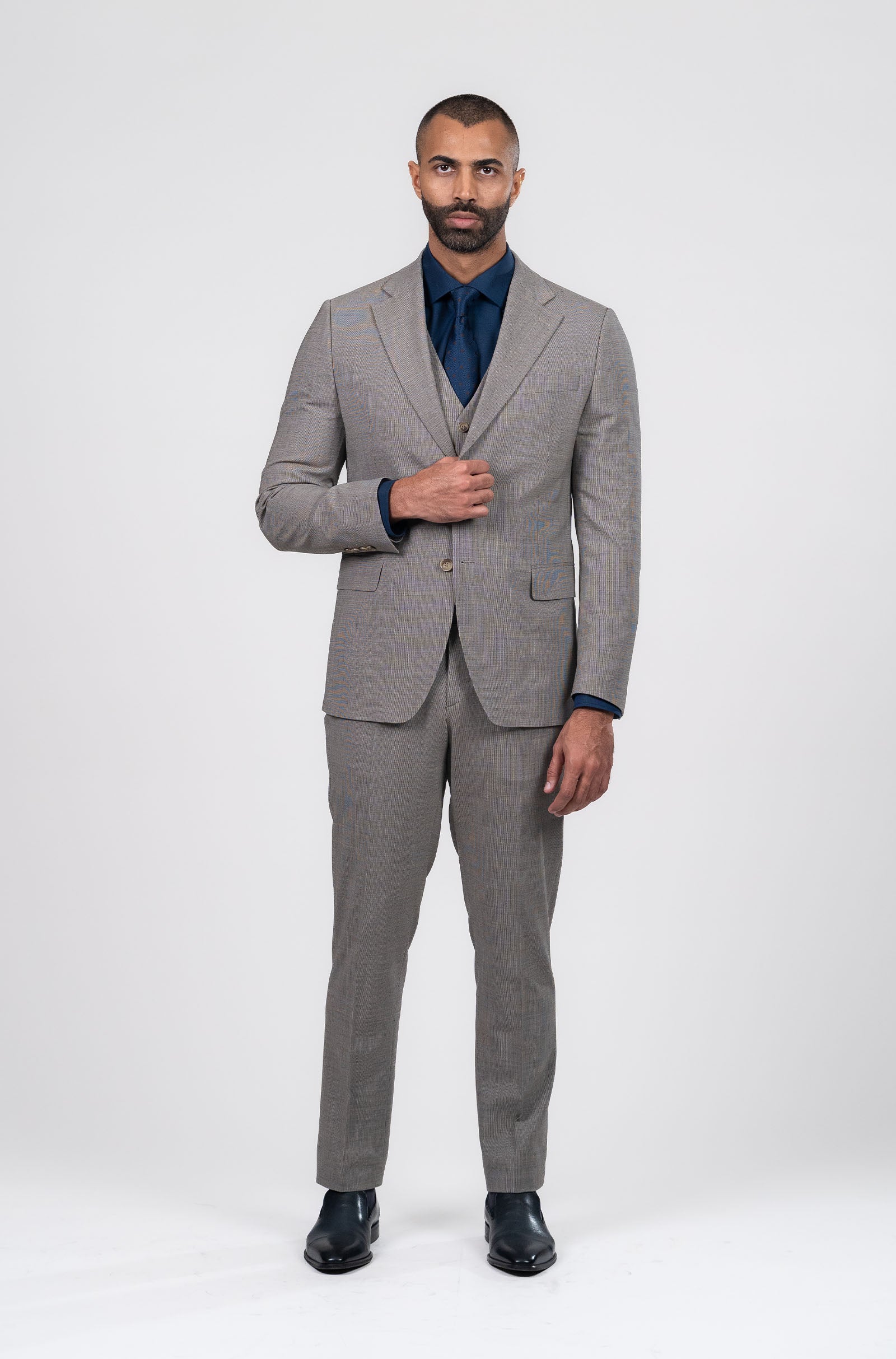 Man wearing a gray suit with a white background