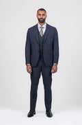 Man wearing a navy suit with a white shirt and tie on a white background