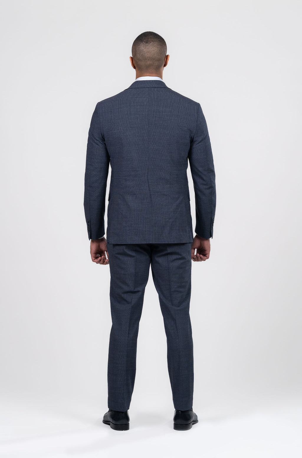 Man wearing a navy suit on a white background