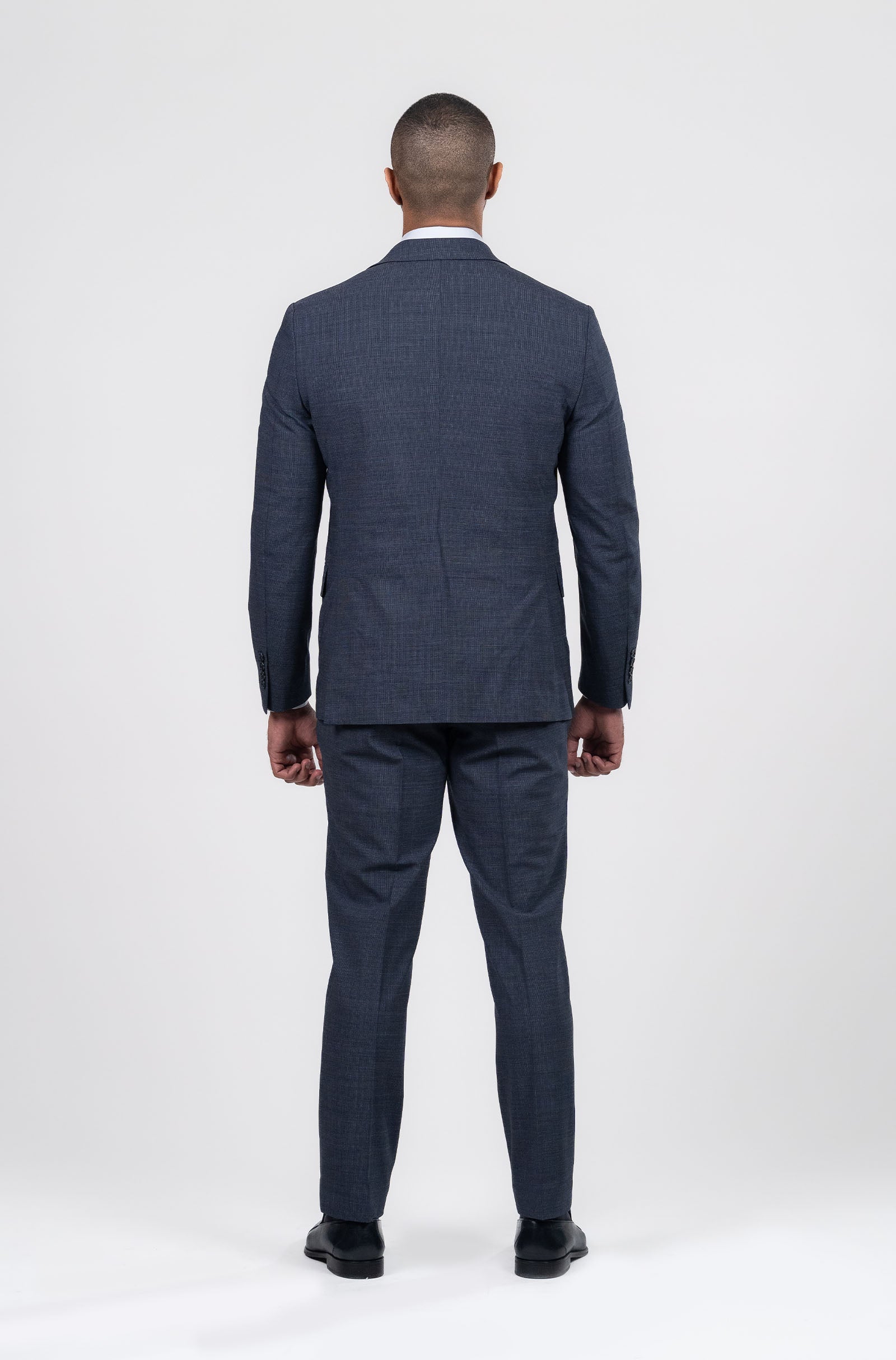 Man wearing a navy suit on a white background