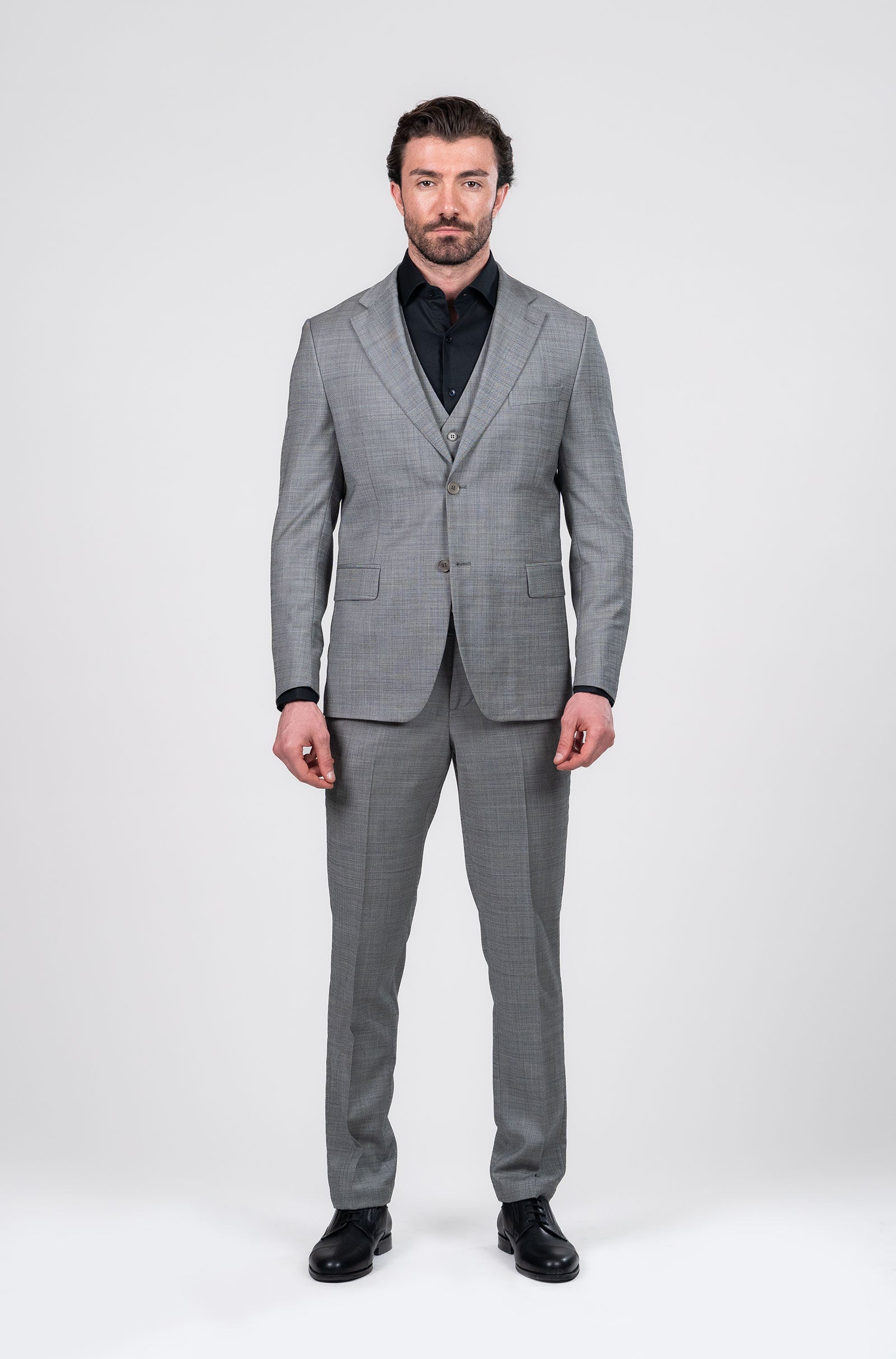 Man wearing a gray suit with a white background